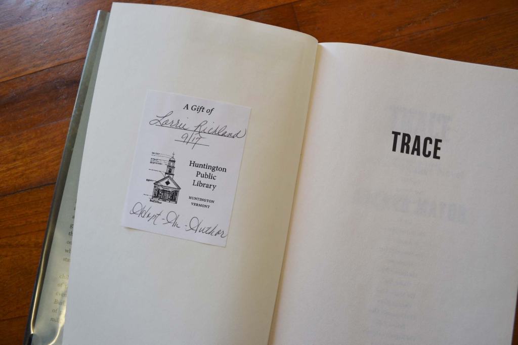 Open book showing an Adopt an Author bookplate