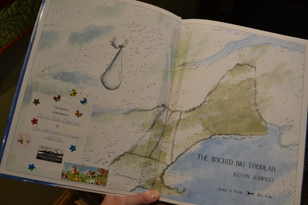 Open children's book showing the bookplate with a baby dedication